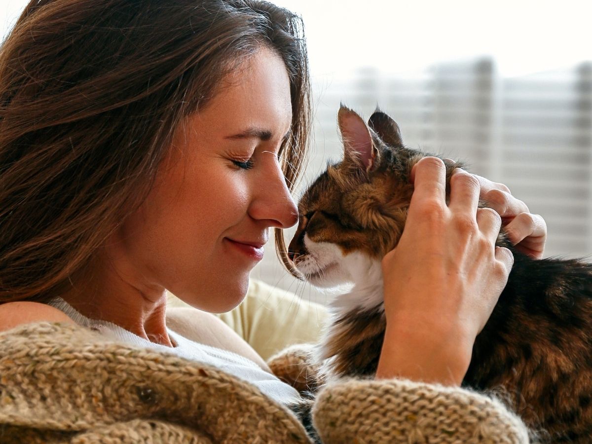 woman holding her cat affectionately