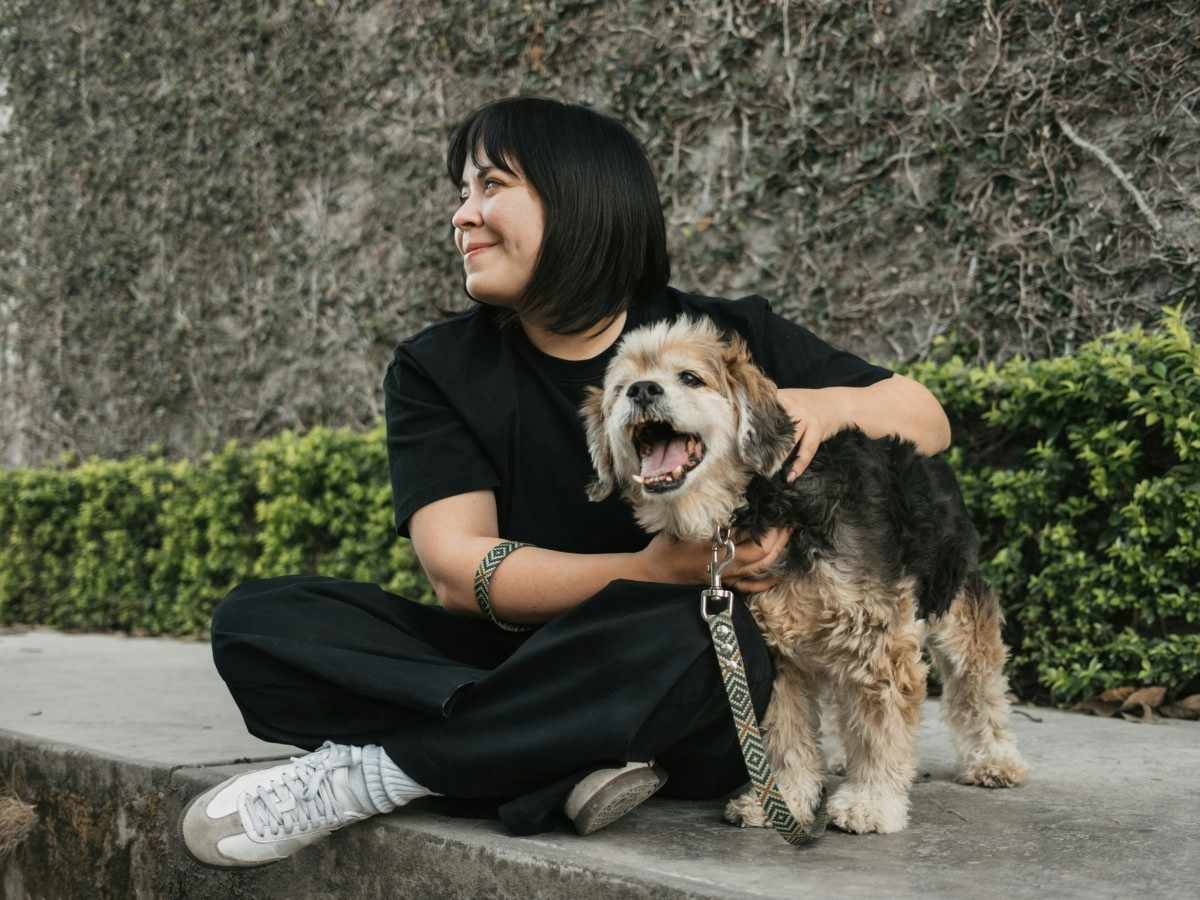 lady in black sitting wih dog lady in black sitting with dog